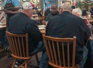 strangers dine with elderly woman at cracker barrel