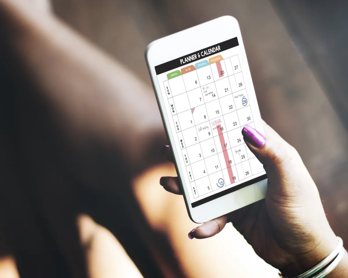 Woman using calendar on her smartphone