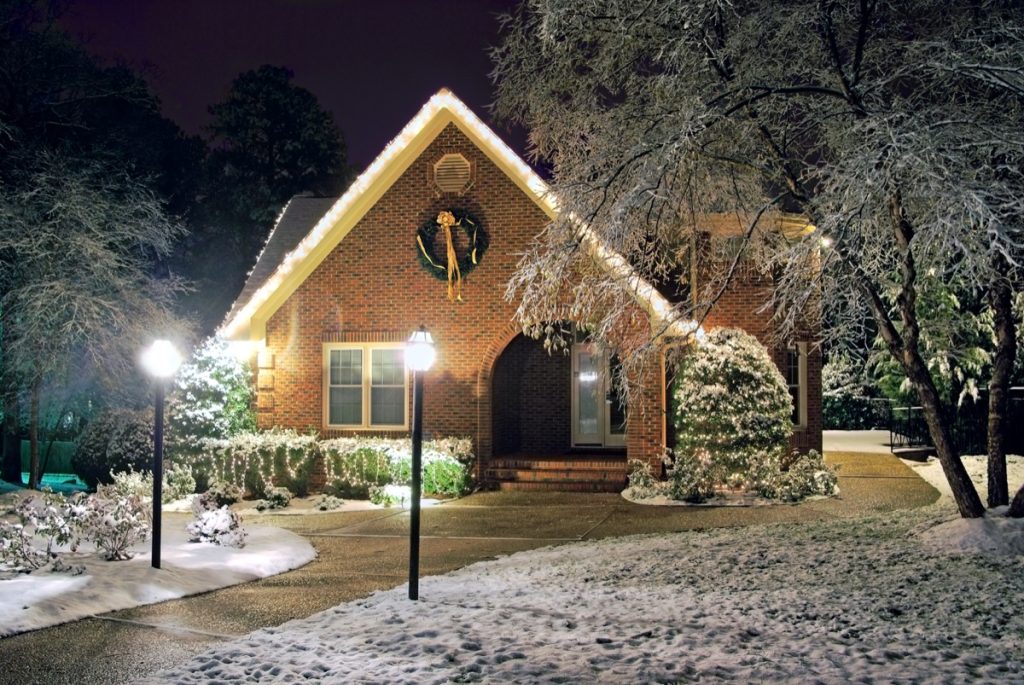 house with exterior lighting in winter