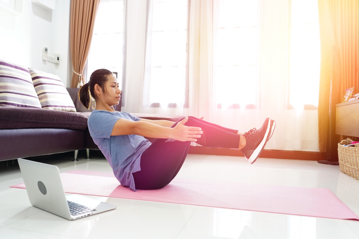 Woman doing an ab exercise workout in the living room