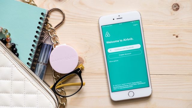 airbnb app on phone next to wallet