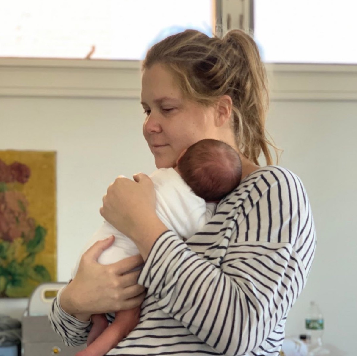 amy schumer holding newborn son gene