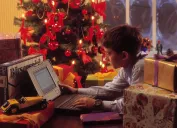 Boy playing with his new computer for Christmas in the 1990s