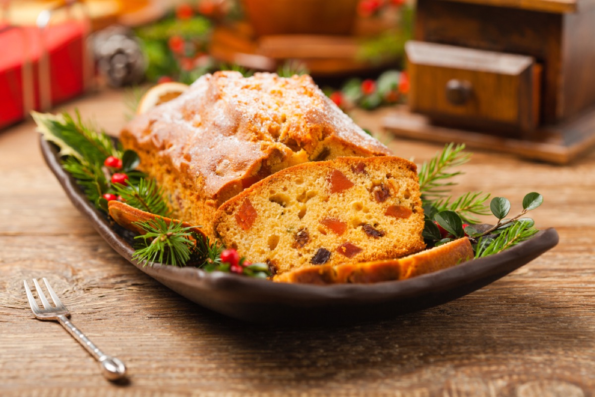 Christmas fruitcake in a serving dish on wooden table