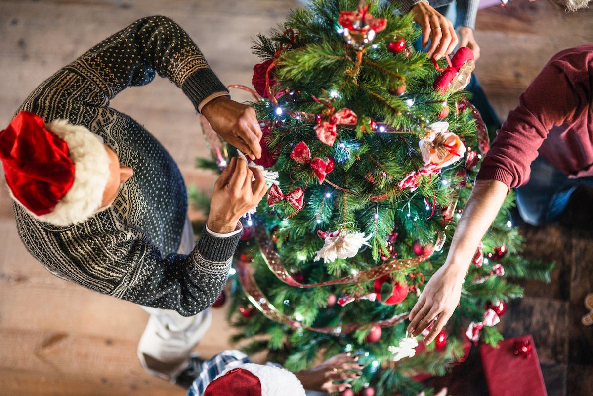 overhead shot of grandparent decorating christmas tree