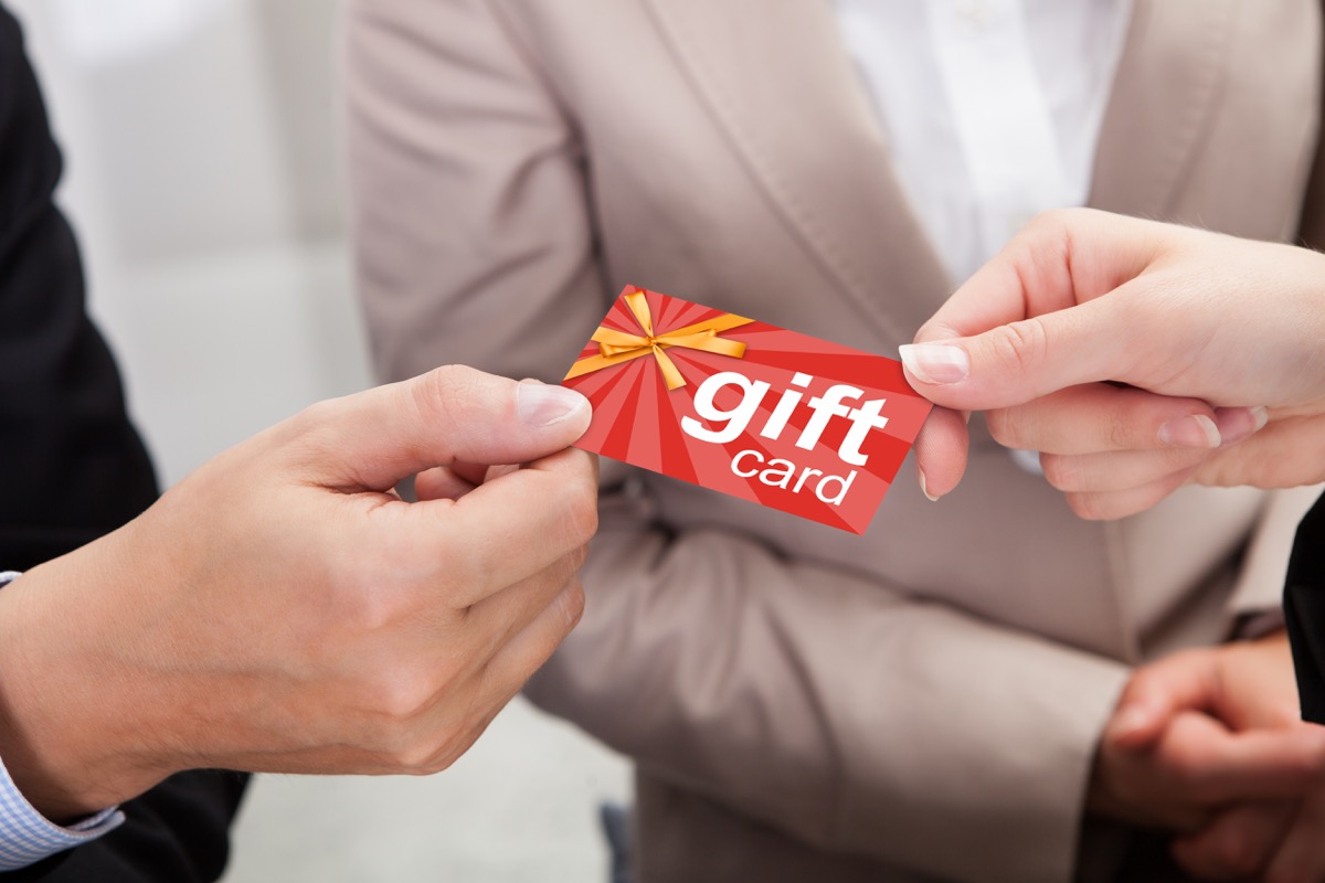 close up of people holding a gift card