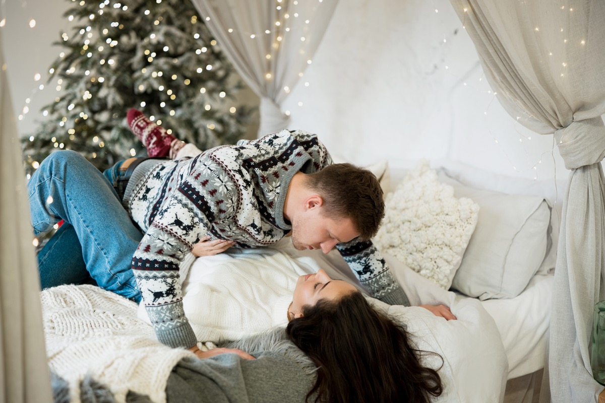 couple in bed in festive room