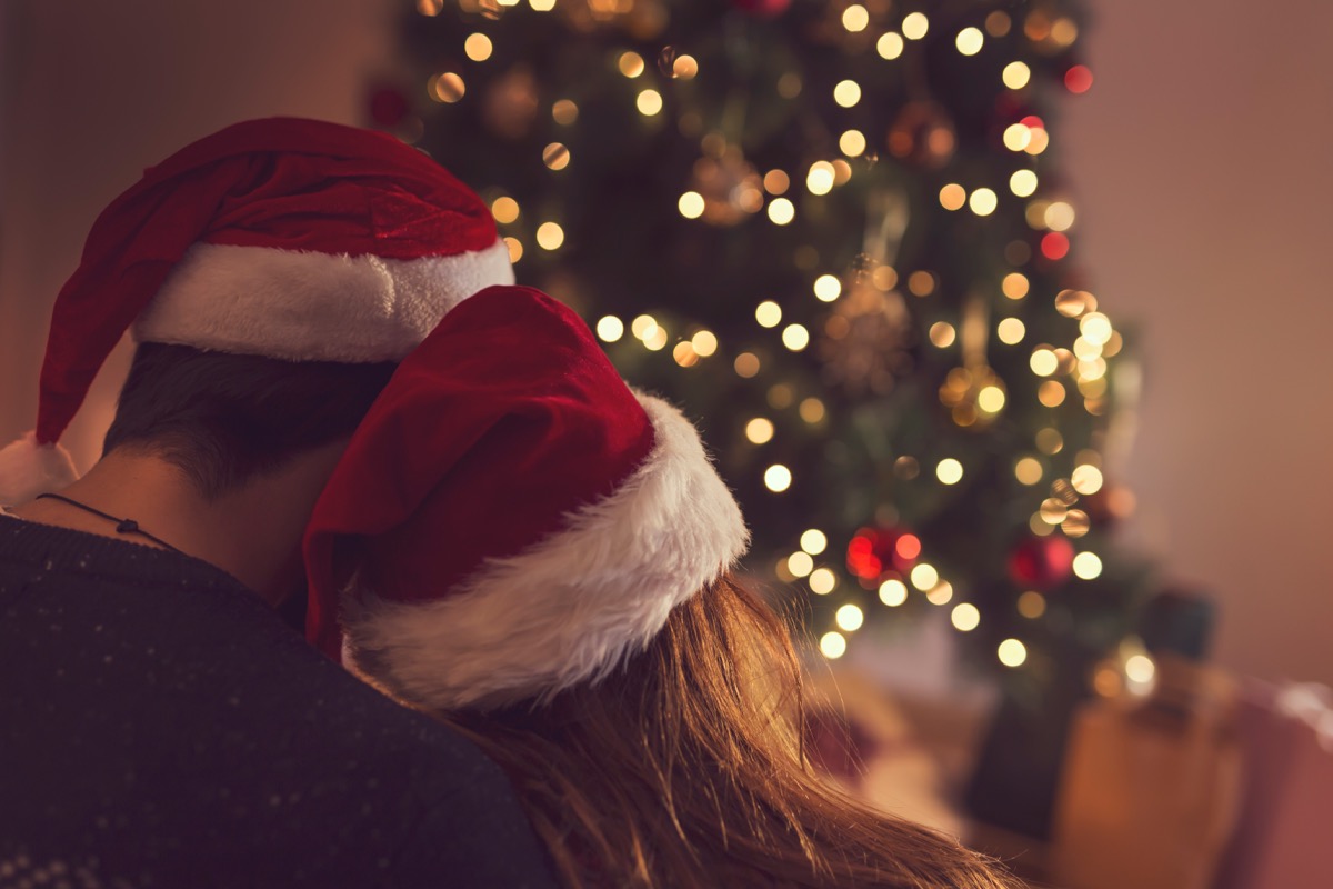 couple in front of christmas tree