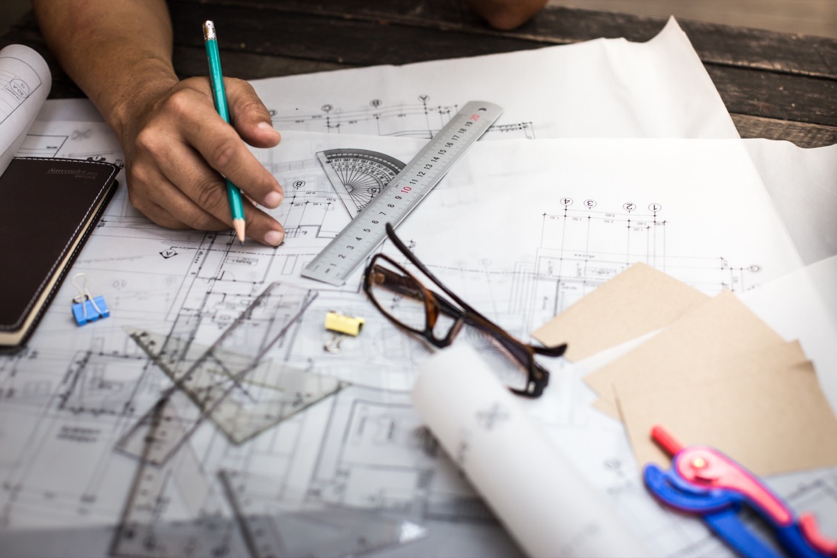 Person making technical drawings for an architect