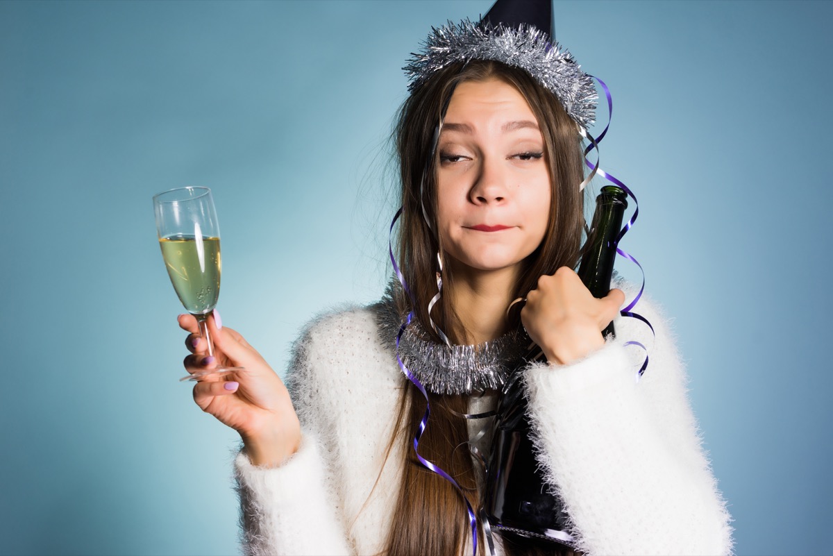 drunk woman holding champagne glass