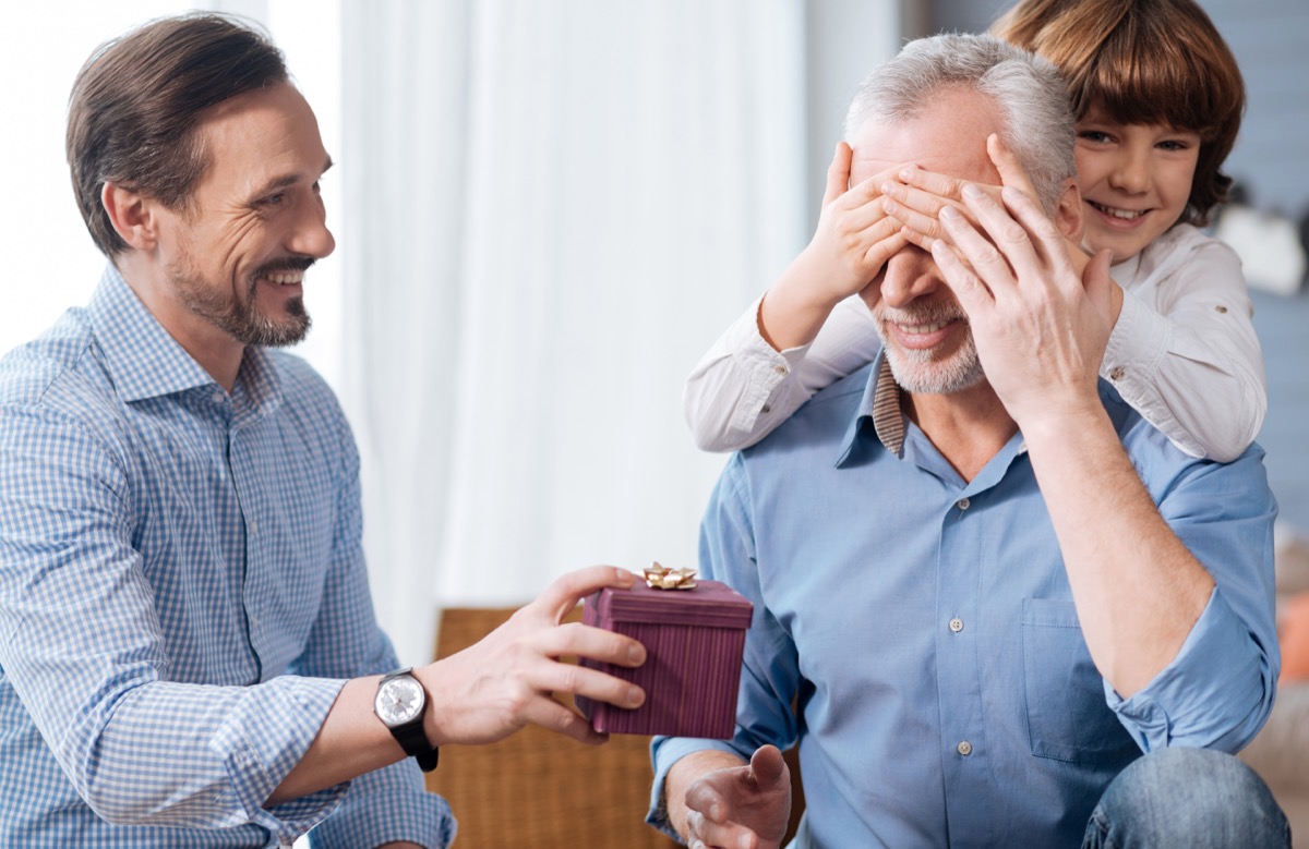 elderly man being surprised with gift