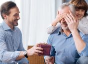 elderly man being surprised with gift