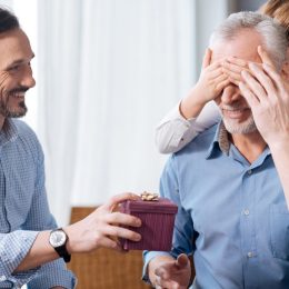 elderly man being surprised with gift