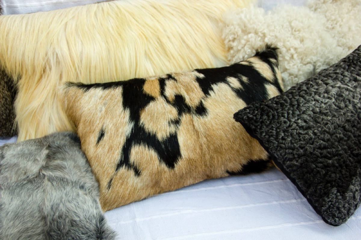 fur pillows on bed