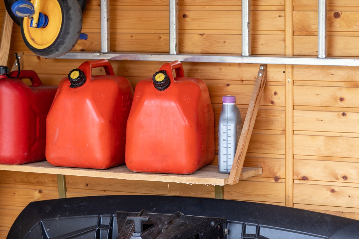 red gas cans on garage shelf
