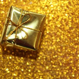 gold christmas gift on gold background
