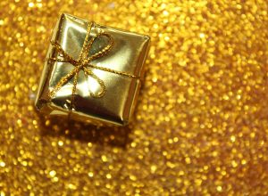 gold christmas gift on gold background