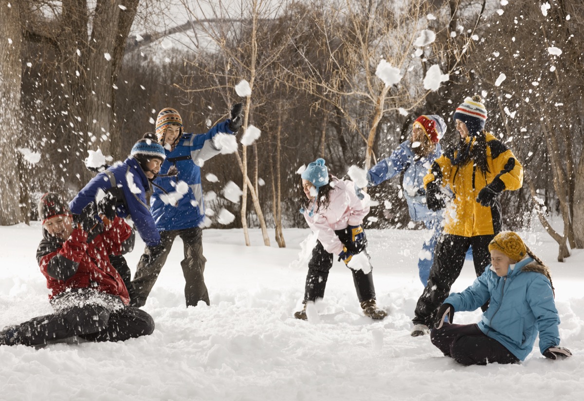group of people having a snowball fight