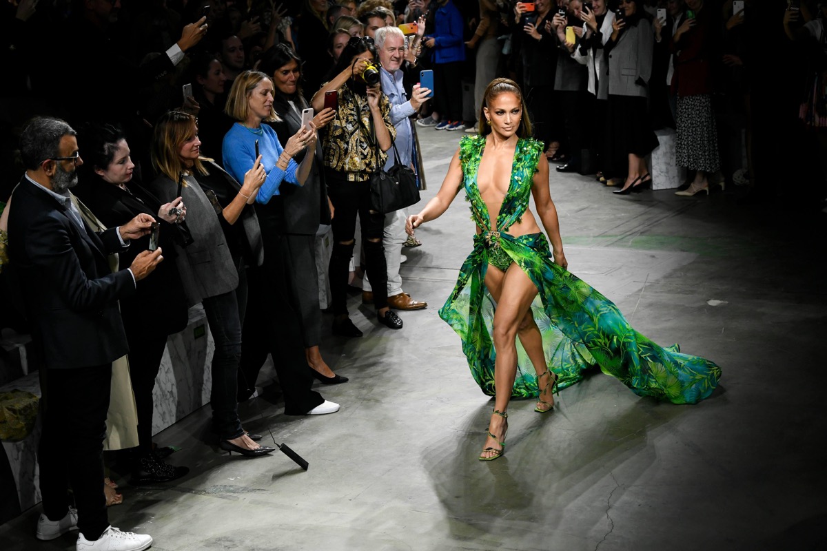 jennifer lopez walking in milan's fashion week wearing a replica of her infamous green versace dress