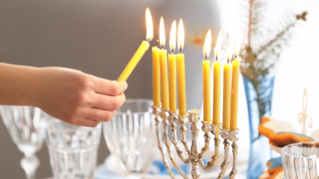 Lighting a menorah for Hanukkah