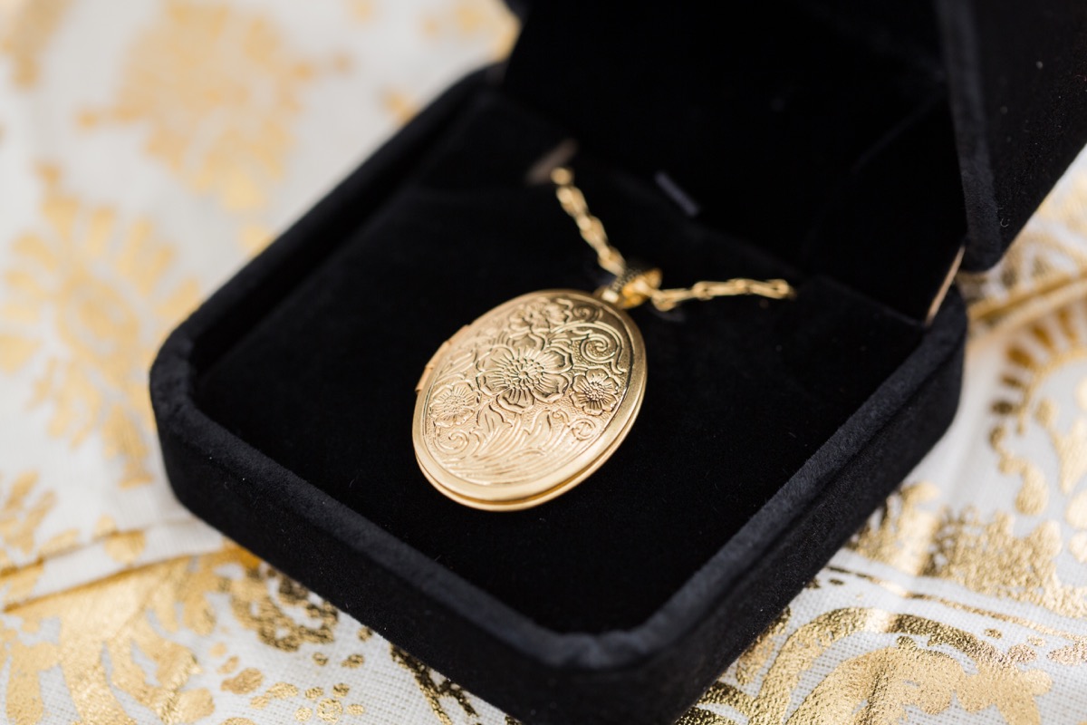An heirloom gold locket necklace in a box