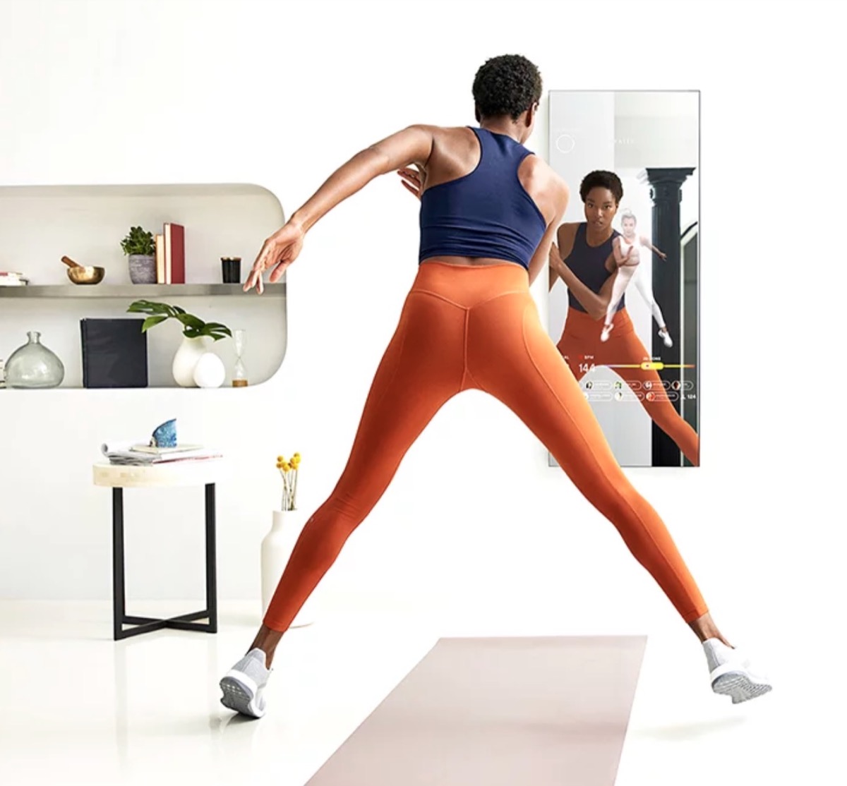young black woman working out in front of mirror