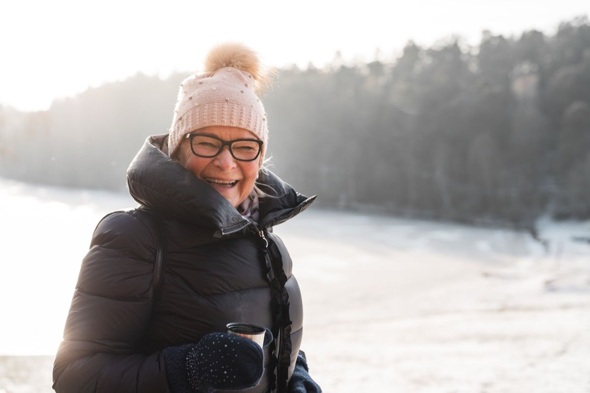 Older woman happy outside in the winter