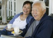 older asian couple drinking tea outdoors