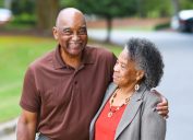 older black couple hugging outdoors