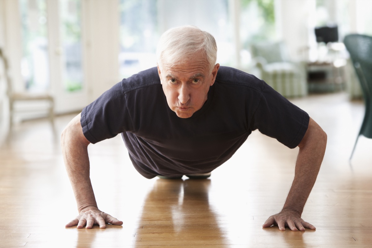 Older man doing push-ups at home