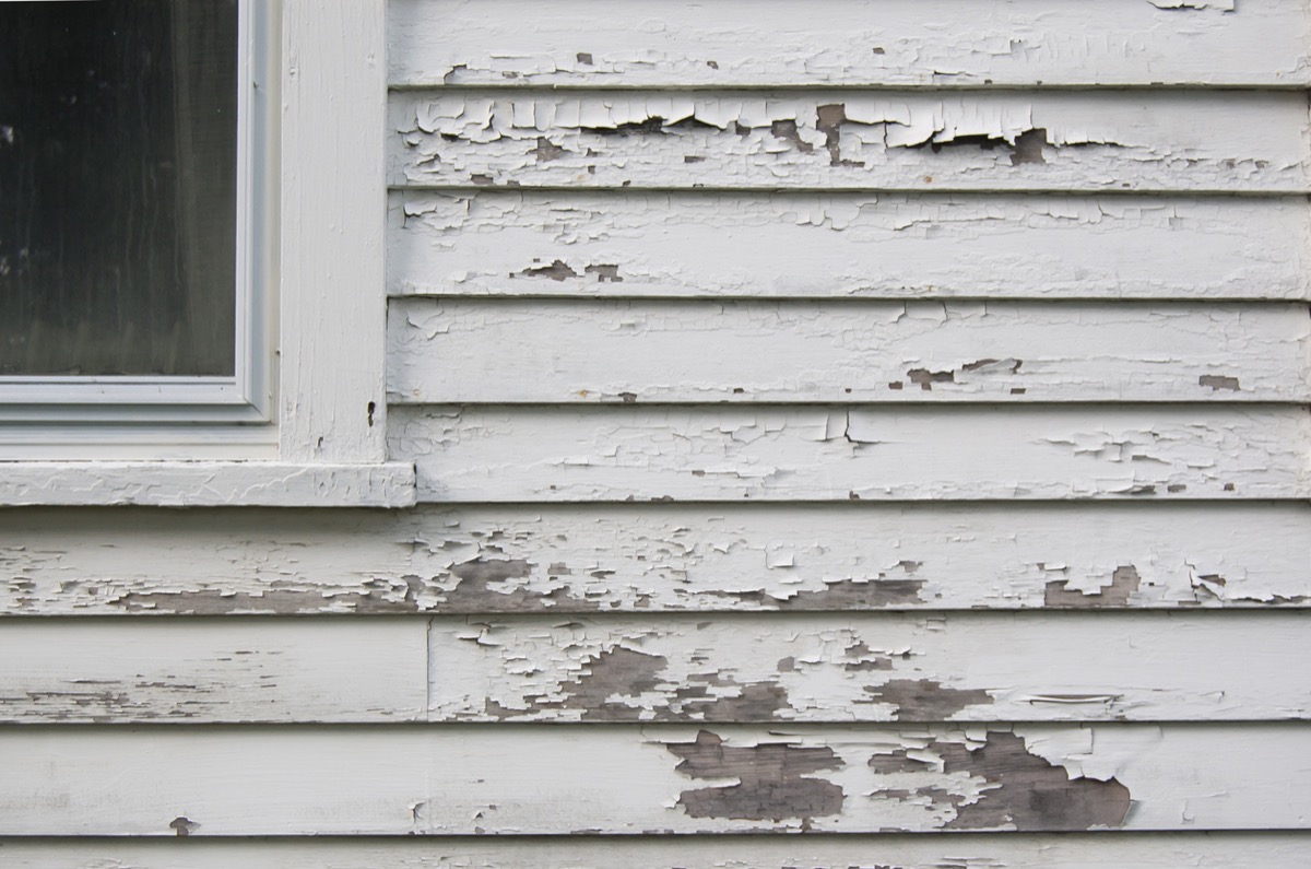 white house with peeling exterior paint
