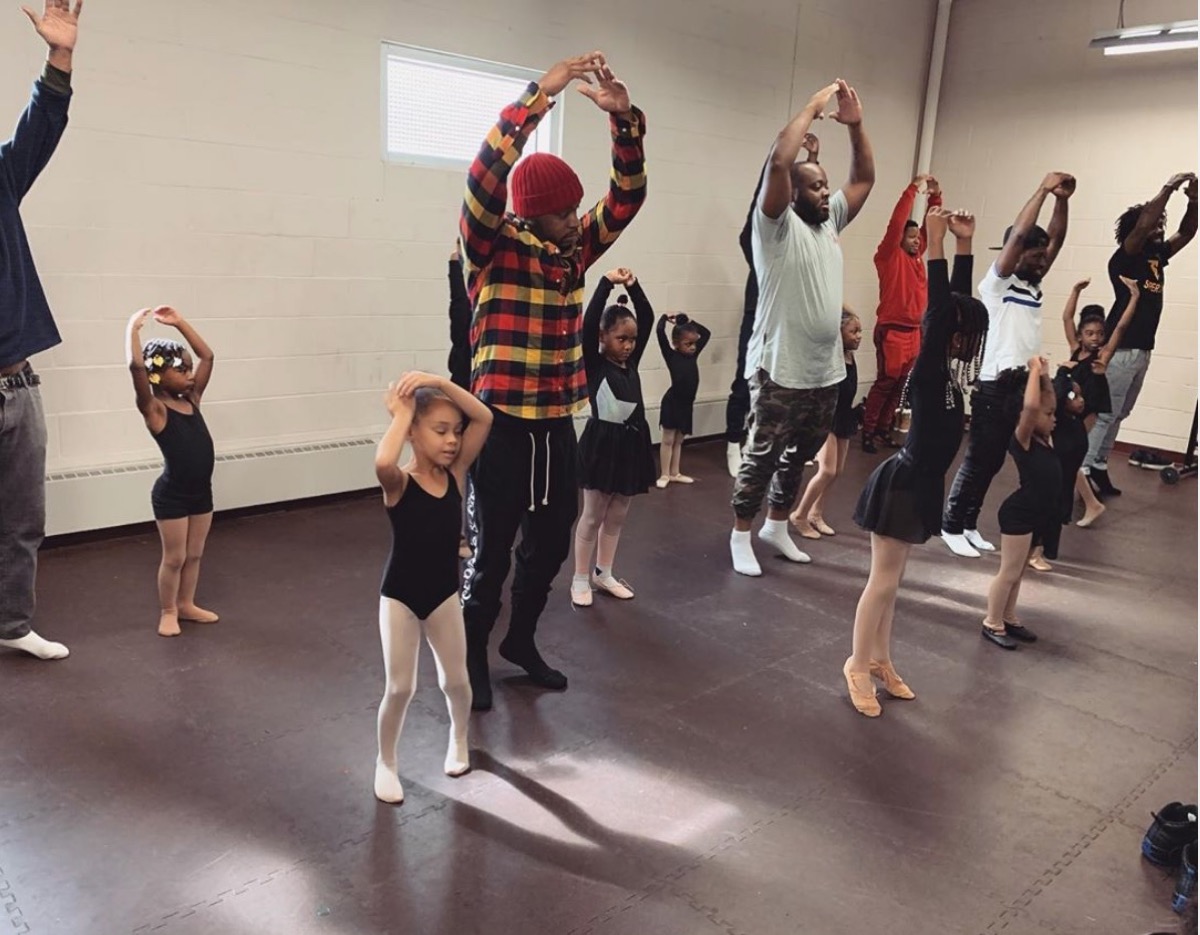 group of black fathers dancing with their daughters at ballet studio