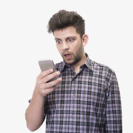 Close-up portrait of shocked young man looking at smart phone's screen receiving bad news on a white background