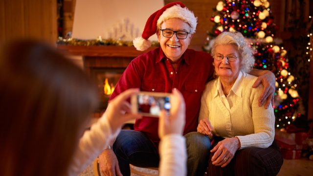 elderly couple takes photo at christmas
