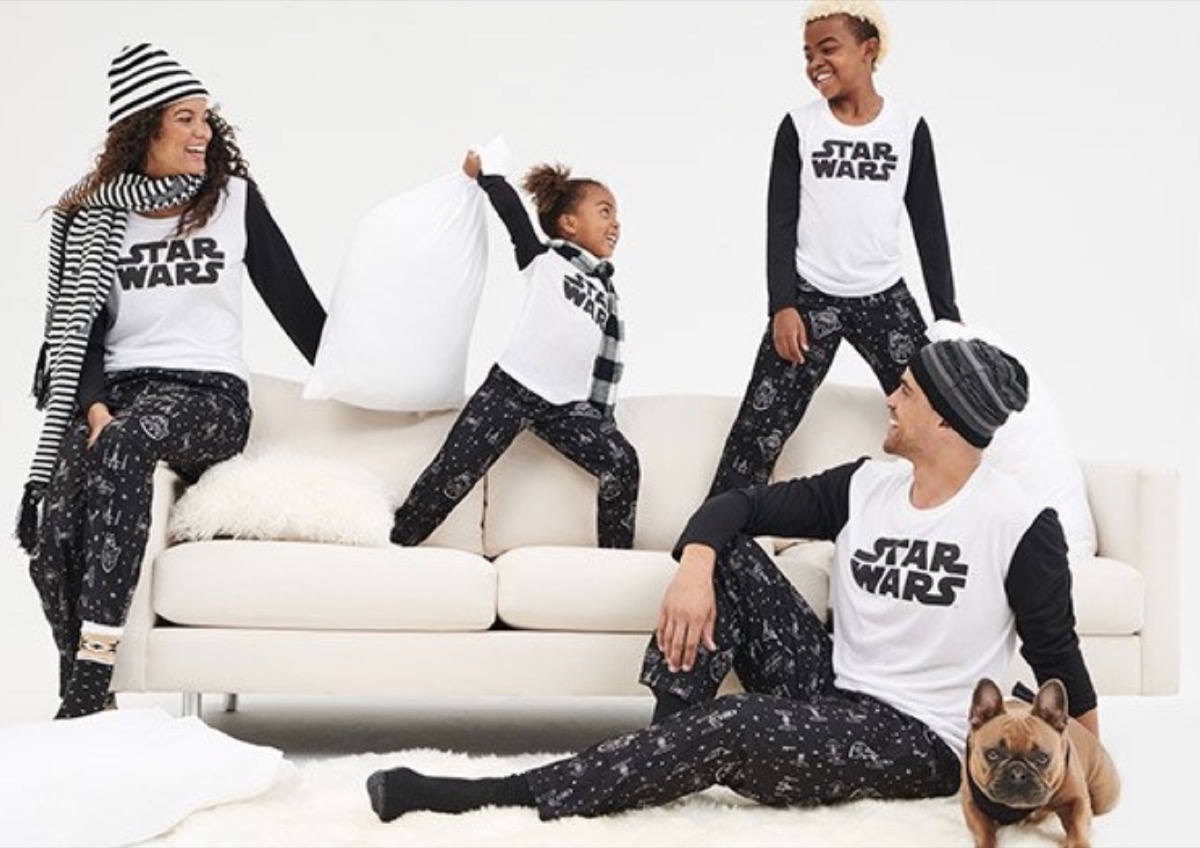 black mother, father, and two children in star wars pajamas on couch