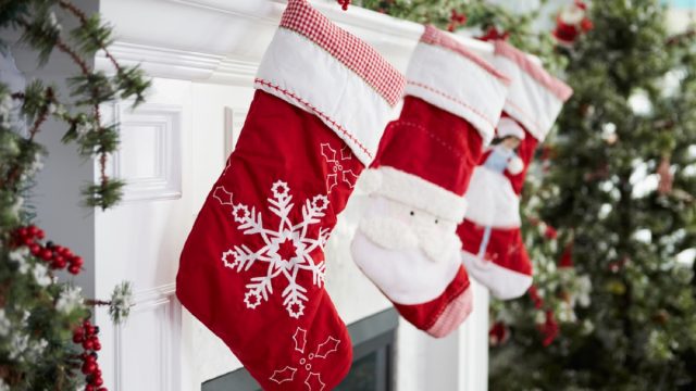 red and white stockings hung on mantle