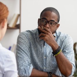 unhappy looking black man having a conversation
