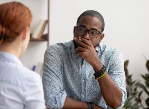 unhappy looking black man having a conversation