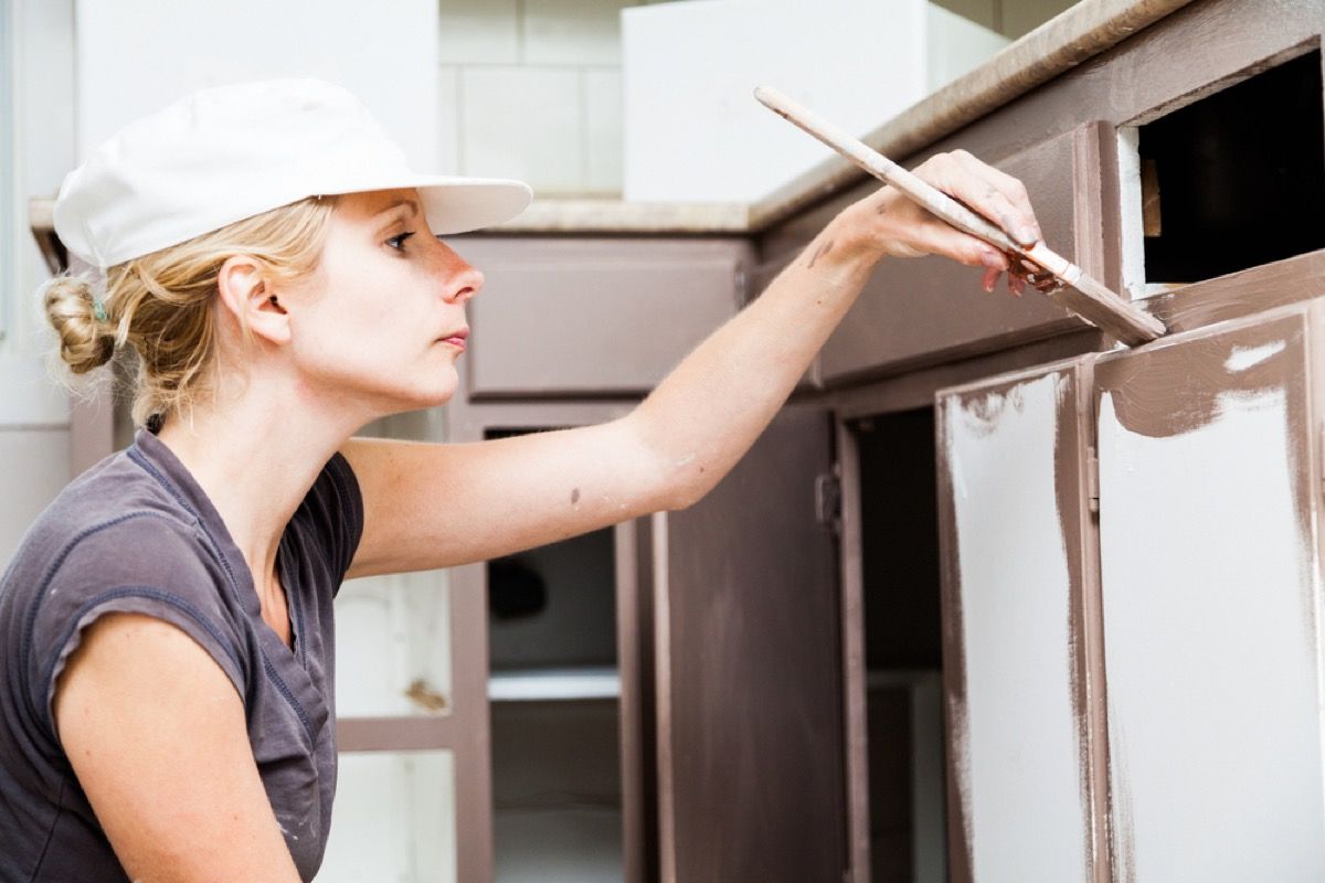 23 Genius Home Improvement Projects You Can Do In An Hour Or Less   Woman Painting Cabinet 