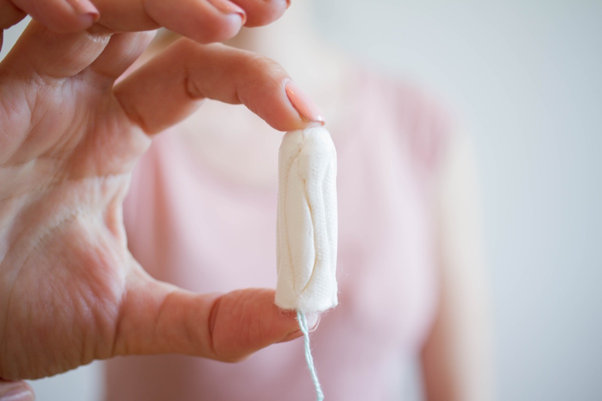 Woman holding a tampon