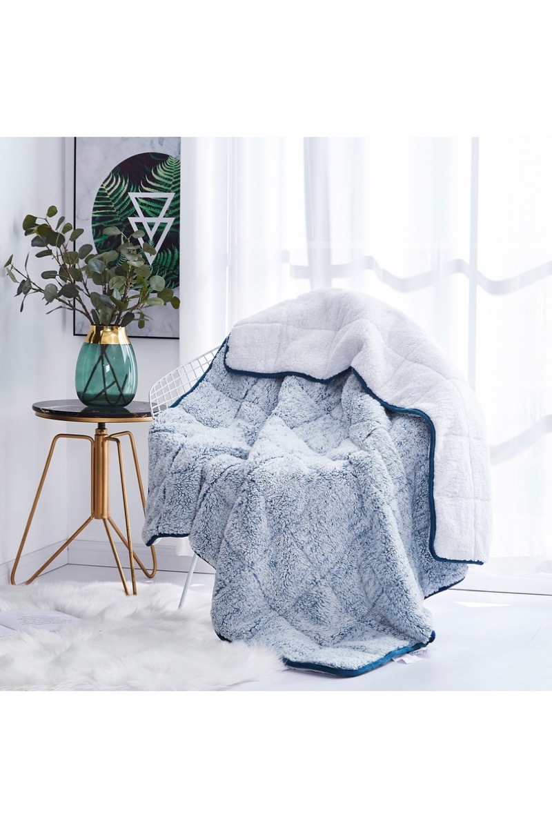 Weighted throw blanket draped over chair