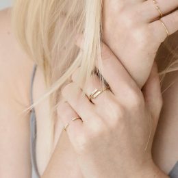 Blonde woman wearing wrap name ring