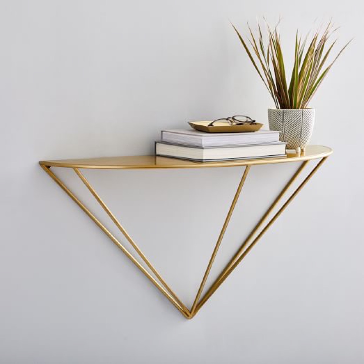 Brass wire wall console with books