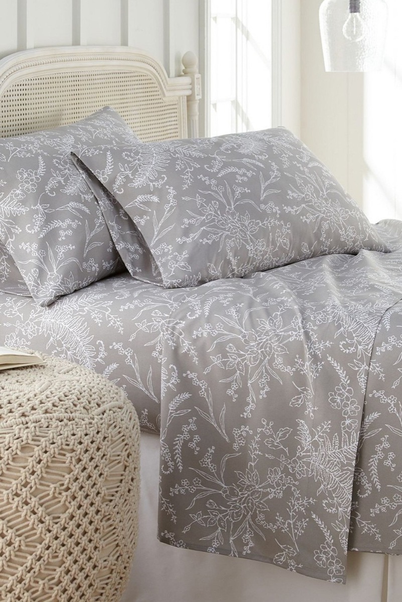 Bed made with gray floral sheets