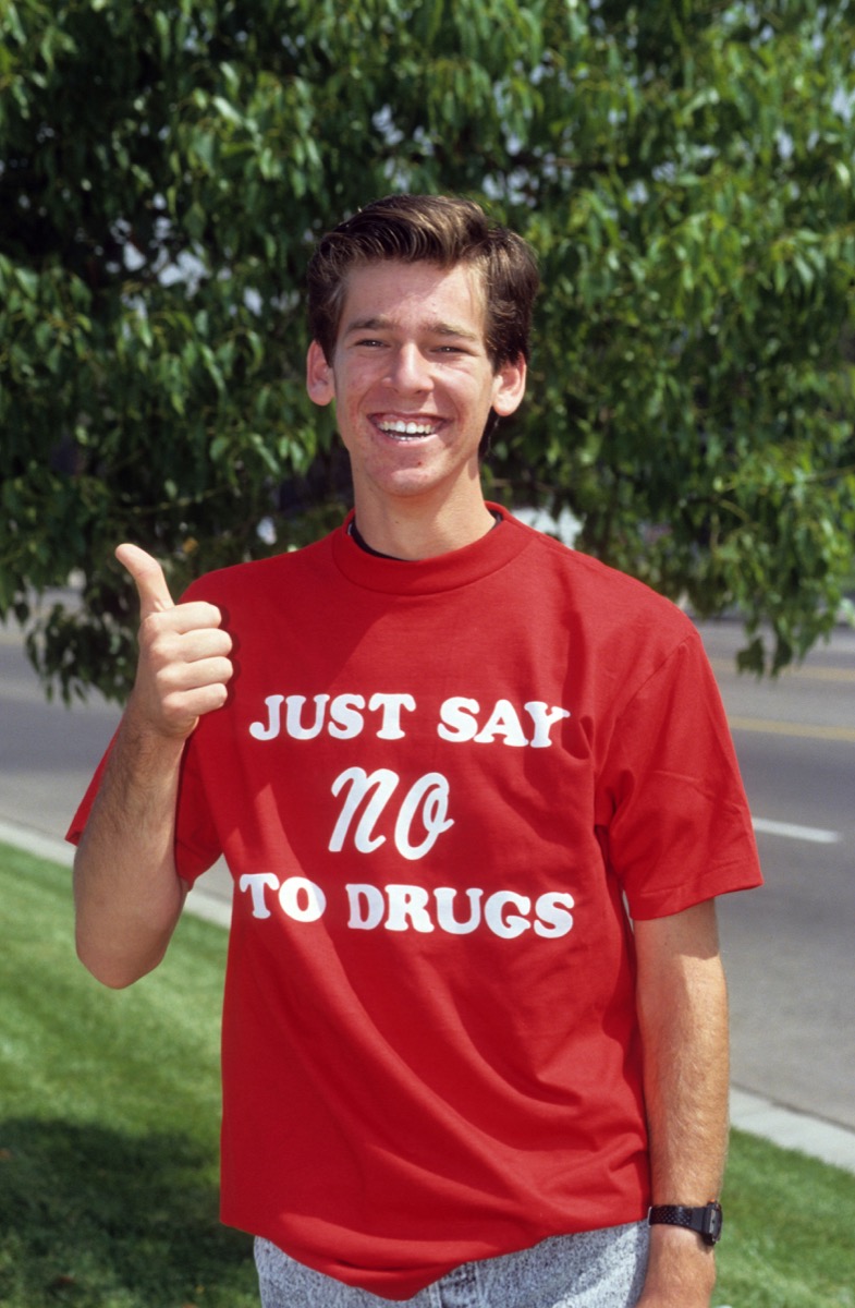 white teenage boy wearing a just say no to drugs shirt and giving a thumbs up