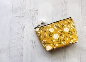 Yellow and white floral bag on wooden floor