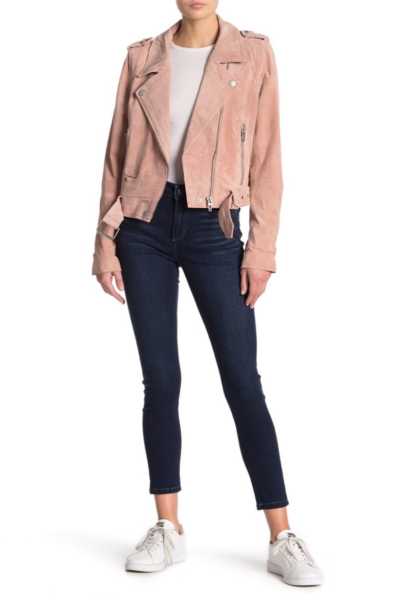 Woman wearing pink jacket and skinny ankle jeans