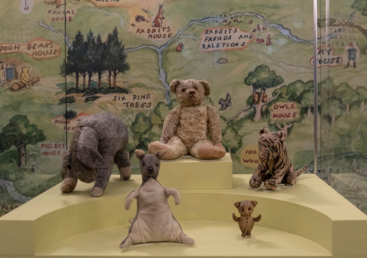 original winnie the pooh stuffed animals on display in the library