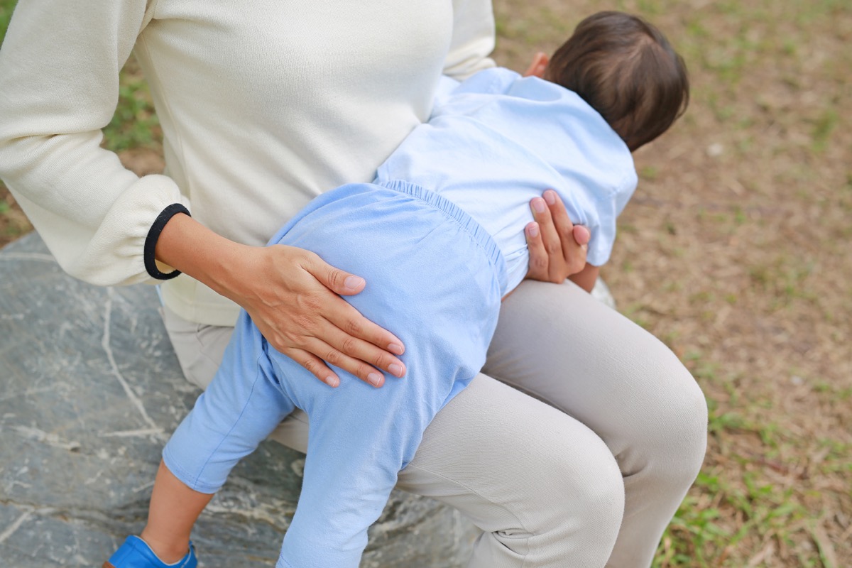 woman spanking child