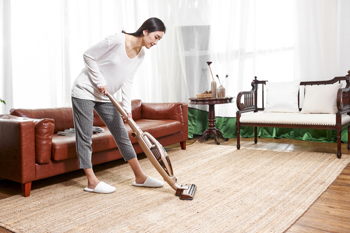 https://bestlifeonline.com/wp-content/uploads/sites/3/2020/01/asian-woman-vacuuming-rug.jpg?quality=82&strip=all
